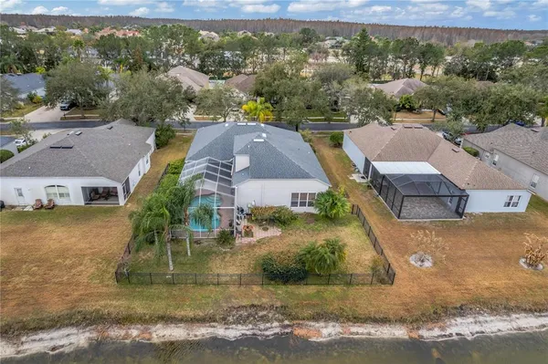 an aerial view of residential houses with outdoor space and swimming pool
