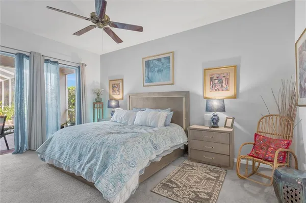 a bedroom with a bed a couch and a window