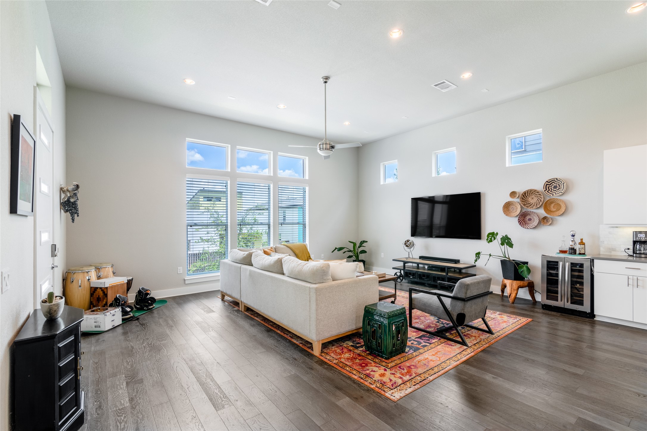 6025 Seville Drive Austin, TX 78724 - Photo 9 of 40 Living area featuring high ceilings, recessed lighting, wood-finish flooring, expansive wall of windows