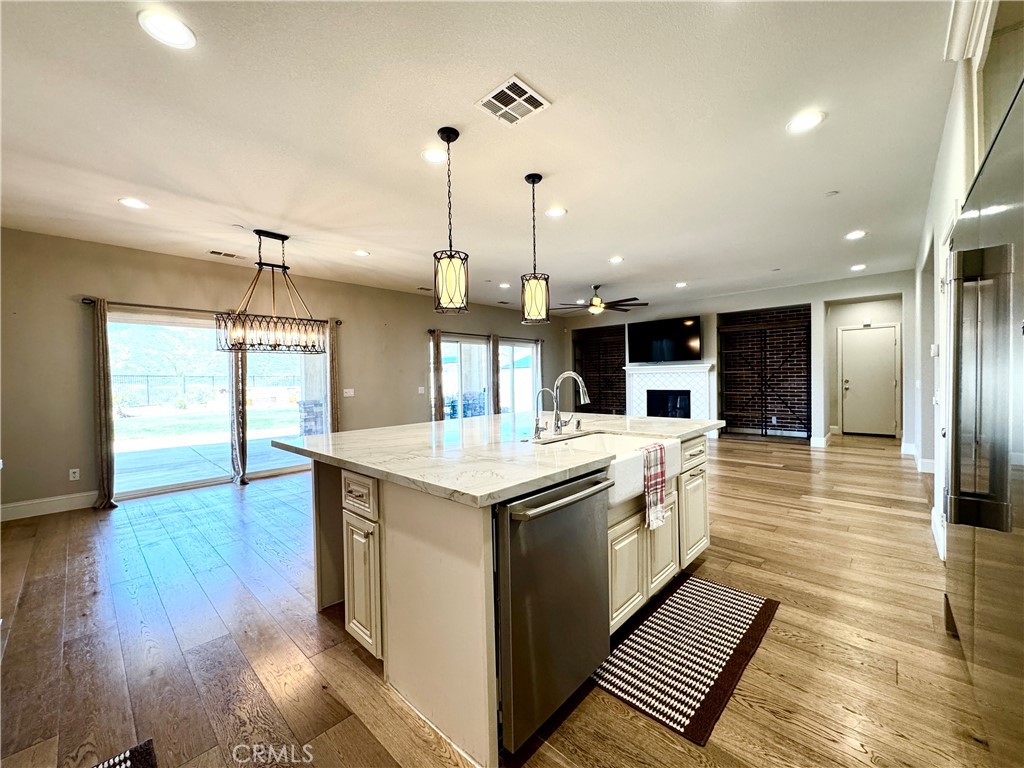 17841 Grapevine Lane San Bernardino, CA 92407 - Photo 19 of 63 a kitchen with stainless steel appliances granite countertop a sink and a wooden floors