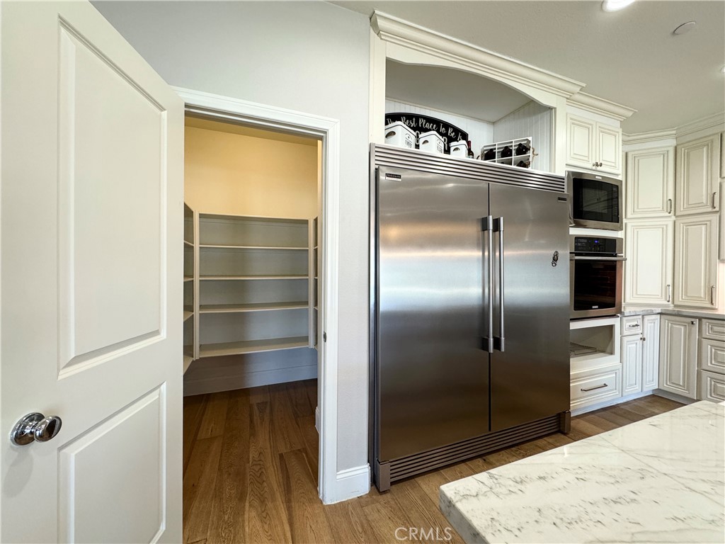 17841 Grapevine Lane San Bernardino, CA 92407 - Photo 22 of 63 a kitchen with a refrigerator and a more cabinets