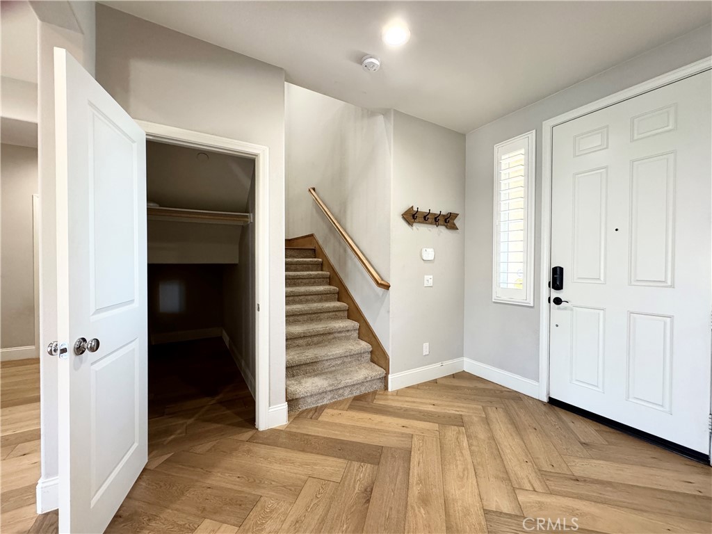 17841 Grapevine Lane San Bernardino, CA 92407 - Photo 25 of 63 a view of a hallway with wooden floor and entryway