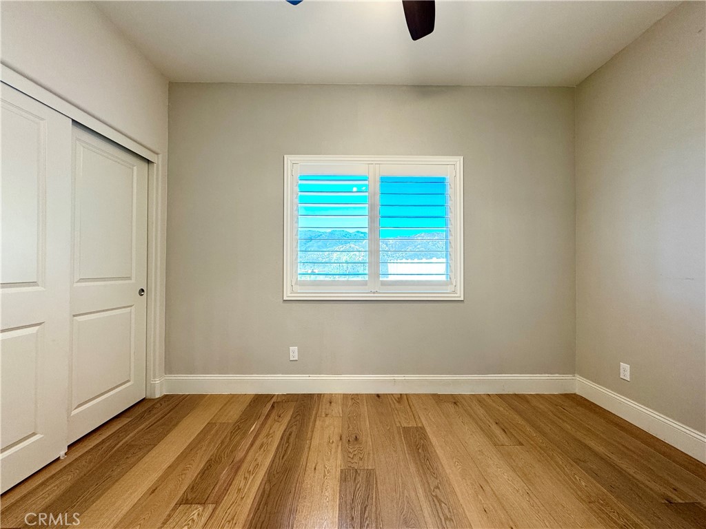 17841 Grapevine Lane San Bernardino, CA 92407 - Photo 30 of 63 a view of an empty room with wooden floor and a window