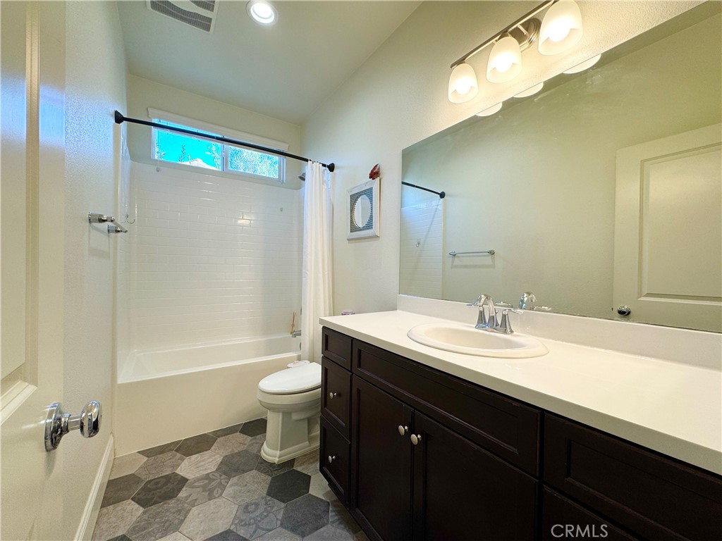 17841 Grapevine Lane San Bernardino, CA 92407 - Photo 31 of 63 a bathroom with a double vanity sink toilet mirror and shower