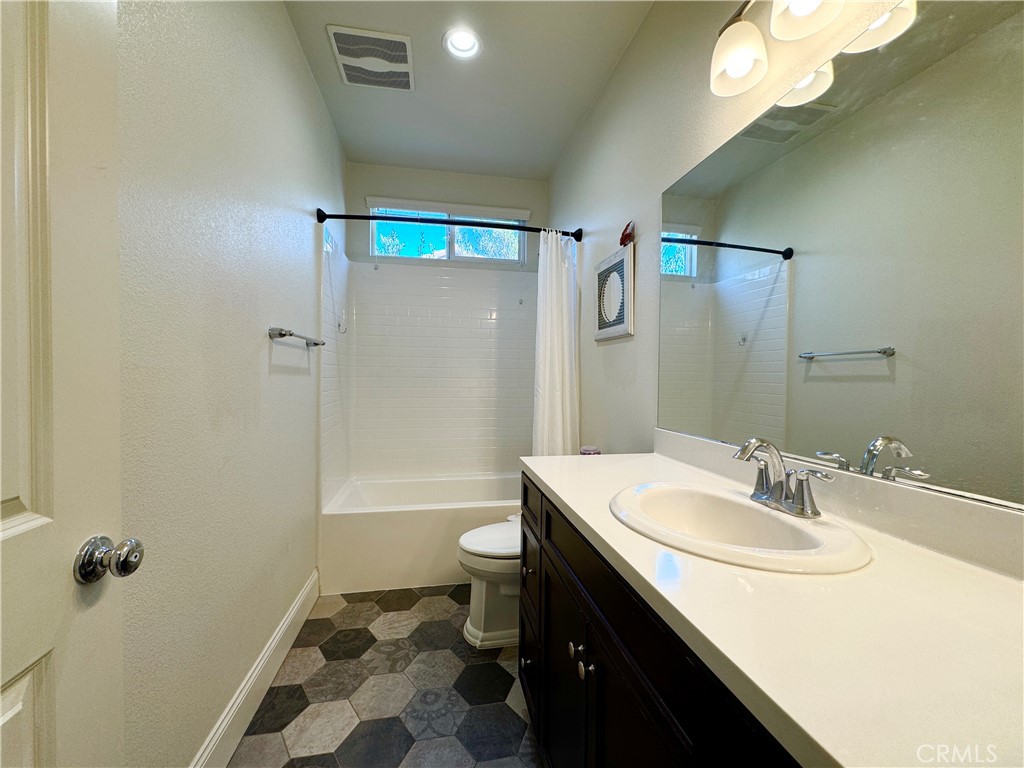 17841 Grapevine Lane San Bernardino, CA 92407 - Photo 32 of 63 a bathroom with a sink a toilet a shower and a mirror