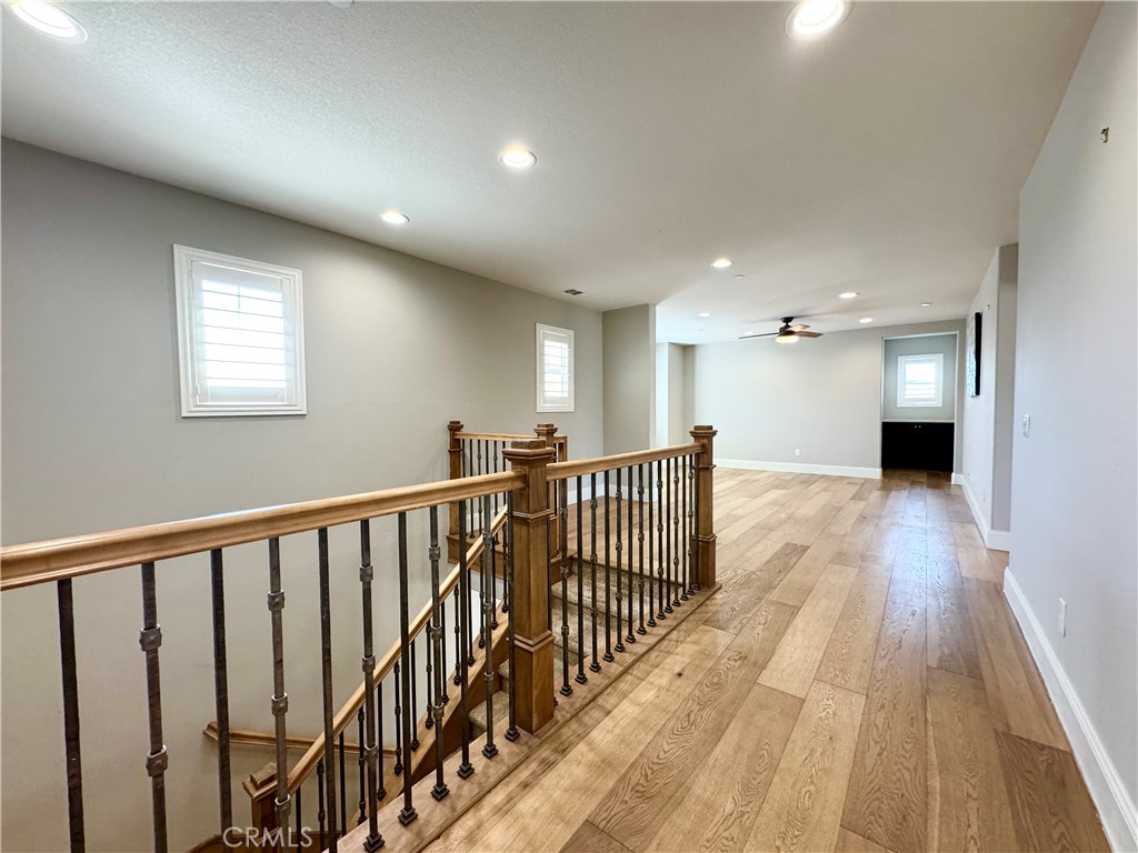 17841 Grapevine Lane San Bernardino, CA 92407 - Photo 35 of 63 a view of a hallway with wooden floor