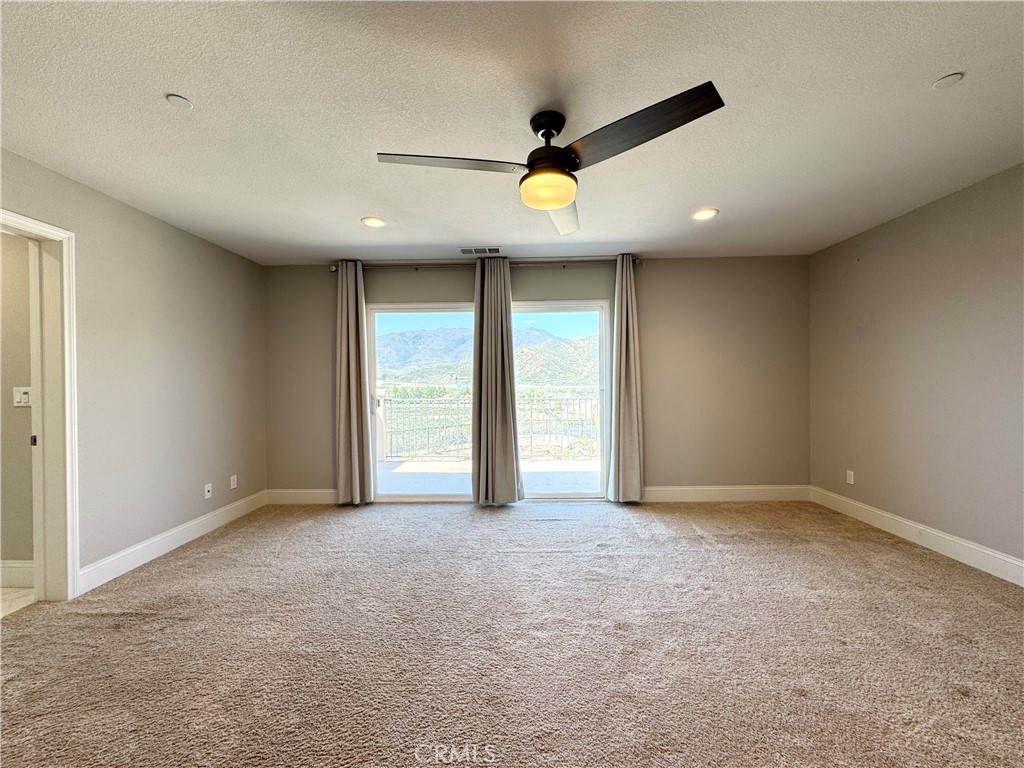 17841 Grapevine Lane San Bernardino, CA 92407 - Photo 41 of 63 an empty room with window and ceiling fan