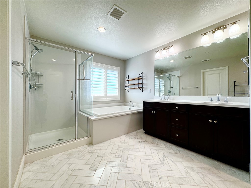 17841 Grapevine Lane San Bernardino, CA 92407 - Photo 44 of 63 a spacious bathroom with a tub sink shower and mirror
