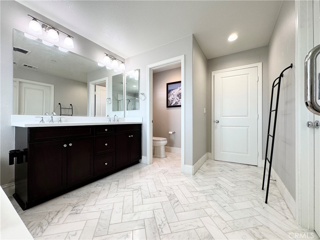 17841 Grapevine Lane San Bernardino, CA 92407 - Photo 45 of 63 a spacious bathroom with a double vanity sink mirror and shower