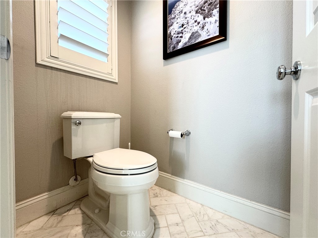 17841 Grapevine Lane San Bernardino, CA 92407 - Photo 46 of 63 a white toilet sitting next to a bathroom sink