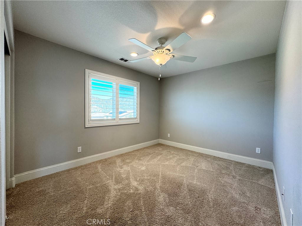 17841 Grapevine Lane San Bernardino, CA 92407 - Photo 53 of 63 an empty room with windows and fan