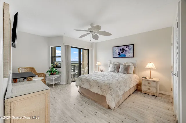 a living room with a bed furniture and a chandelier