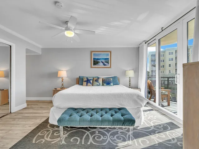 a bedroom with a bed mirror and a window