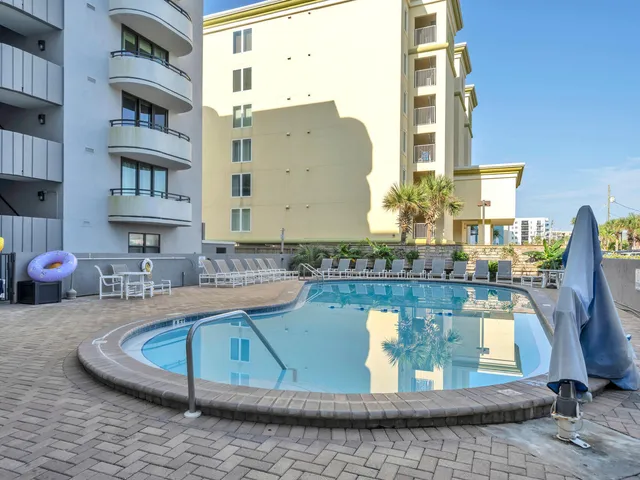 a view of a swimming pool with outdoor seating