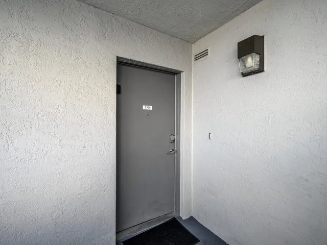 a room with a wooden floor and mirror