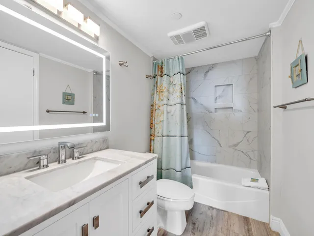 a bathroom with a sink toilet and shower