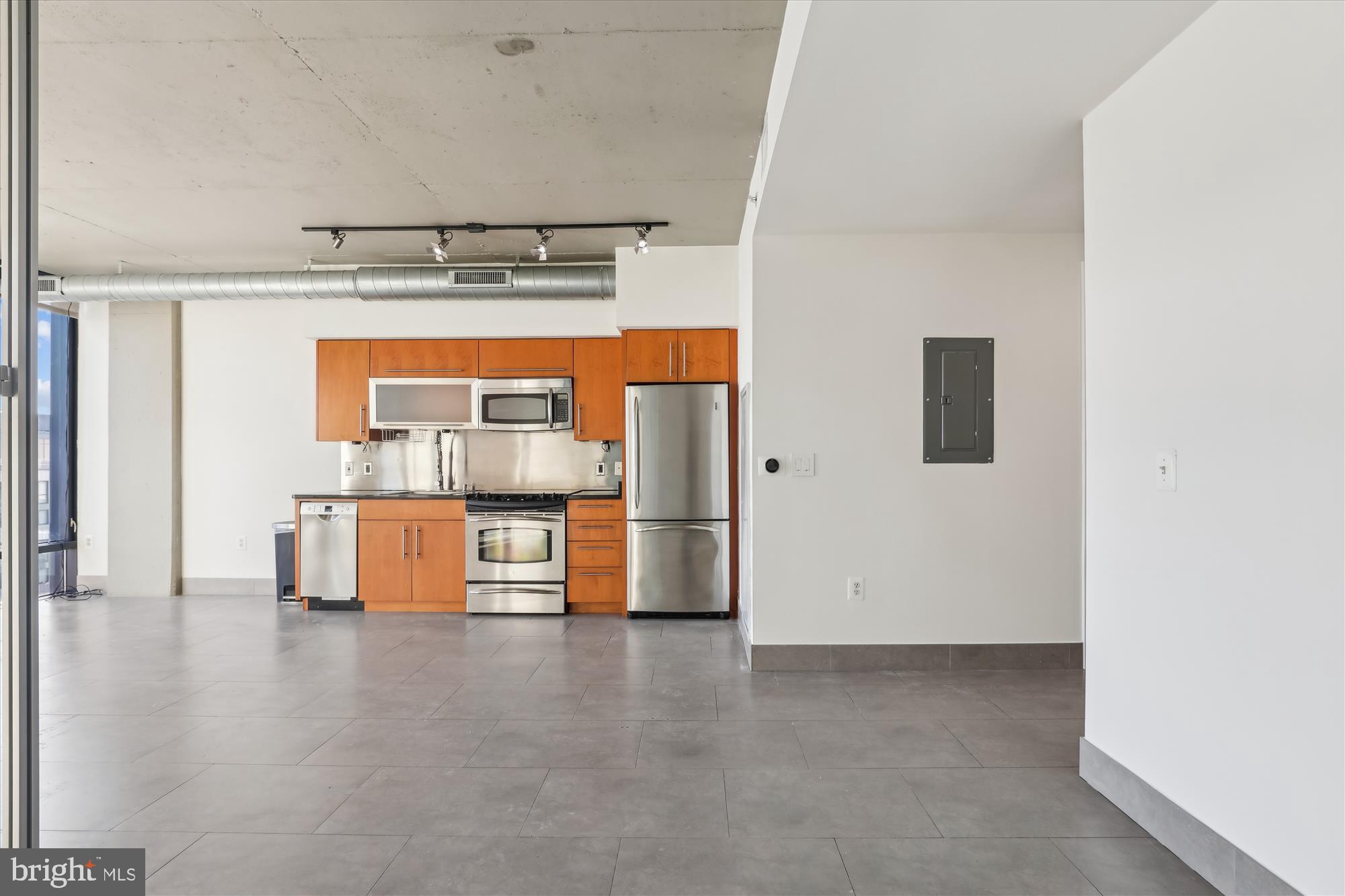 1133 14th Street Northwest, Unit 1209 Washington, DC 20005 - Photo 15 of 42 a living room with stainless steel appliances furniture and a kitchen view
