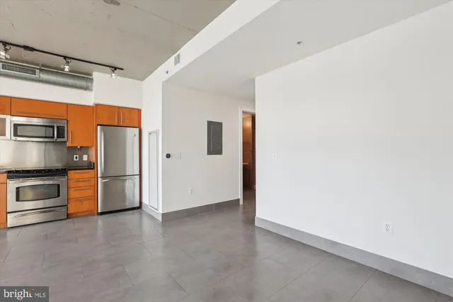 a view of a kitchen with a refrigerator a stove top oven