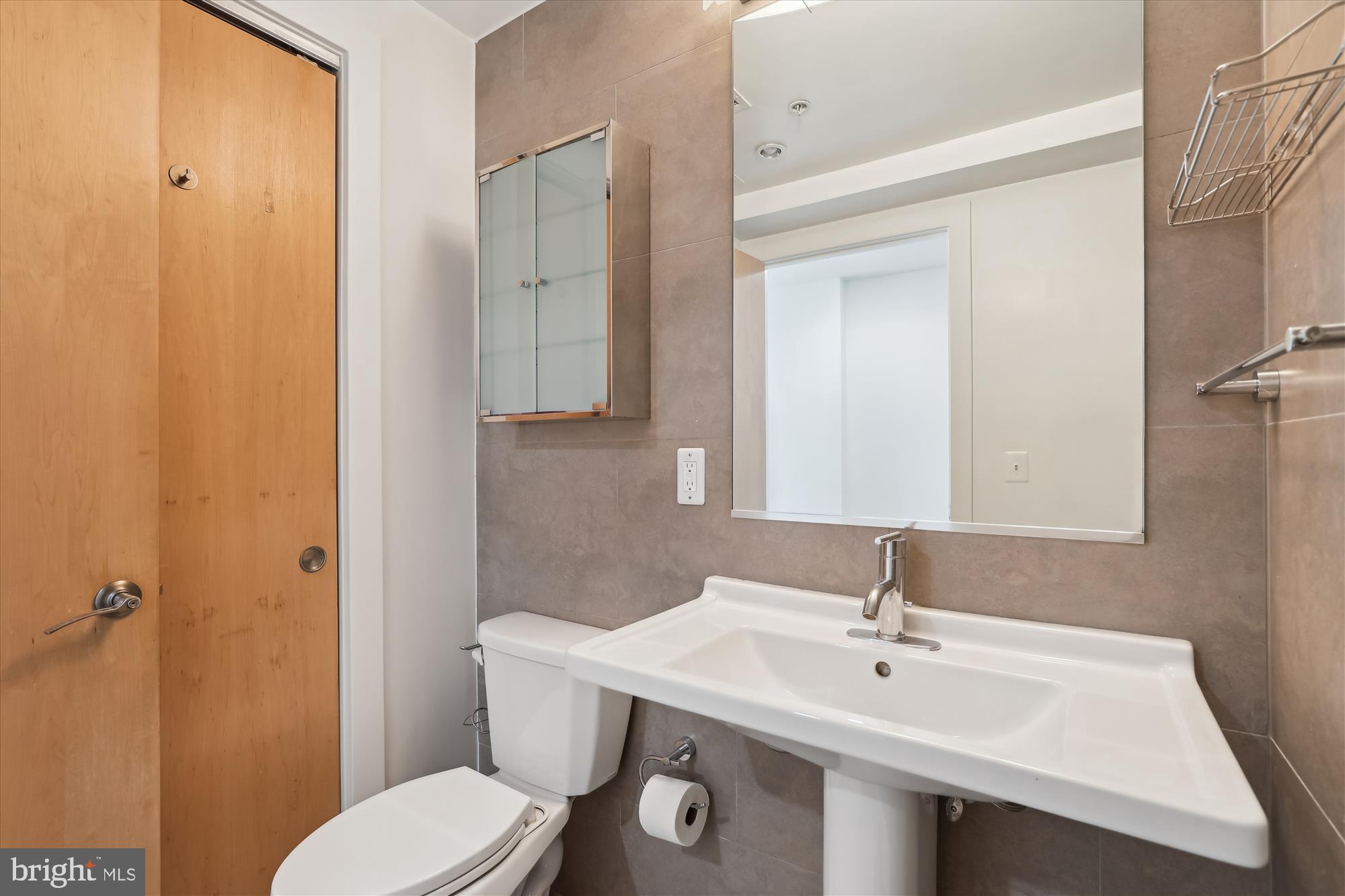 1133 14th Street Northwest, Unit 1209 Washington, DC 20005 - Photo 19 of 42 a bathroom with a toilet a sink and mirror