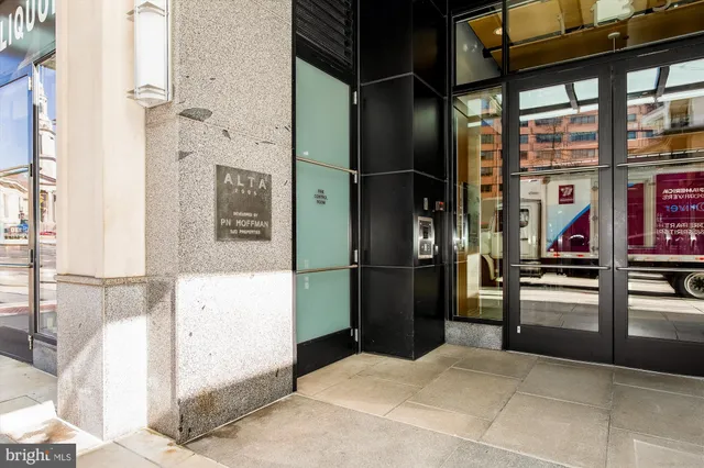 a kitchen with stainless steel appliances kitchen island granite countertop a refrigerator and a sink
