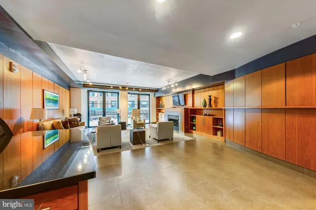 a living room with furniture pool table and sofas