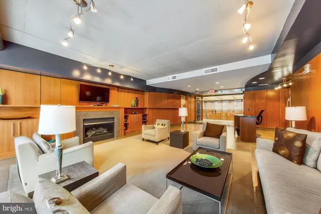 a living room with furniture fireplace and a large window