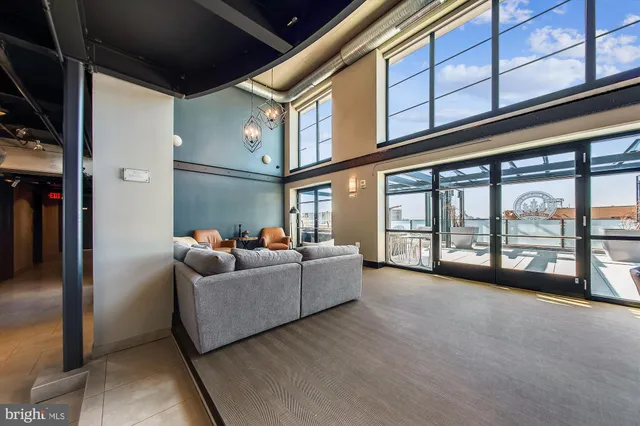 a living room with furniture and a floor to ceiling window