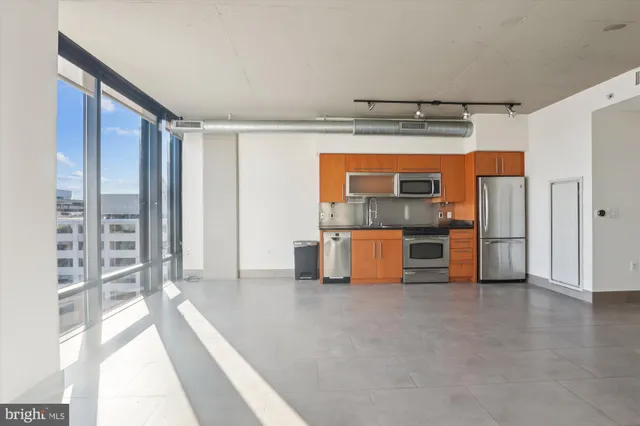 a view of a room with cabinet and refrigerator