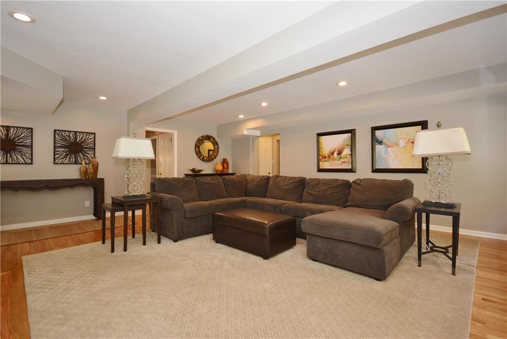 104 Hawthorne Road Fox Chapel, PA 15238 - Photo 12 of 24 Expansive family room with recessed lighting and marble-faced fireplace.