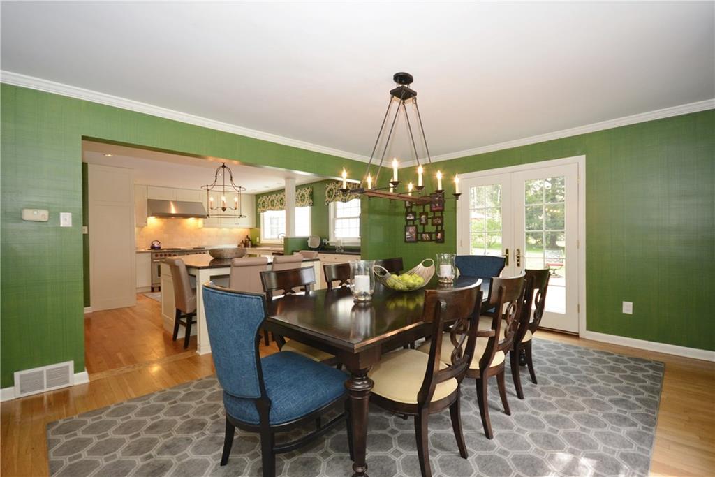 Open concept kitchen and dining room with French doors to patio. 