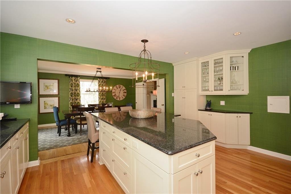 Wrought iron chandeliers with built-in Brookhaven cabinetry.  