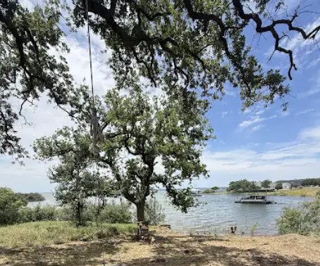 4215 Sunset Cliff Road Burnet, TX 78611 - Photo 8 of 13 A tranquil lakefront setting, ideal for enjoying serene water views and outdoor leisure.
