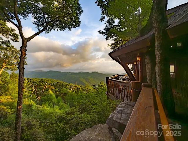 a view of a balcony with wooden floor and fence