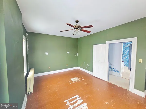 a view of a livingroom with a ceiling fan and a window