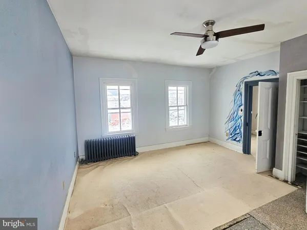 a view of livingroom with hardwood floor and a ceiling fan