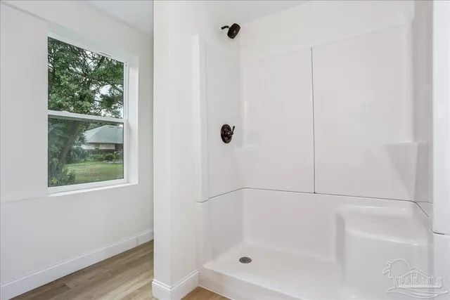 a view of an empty room with wooden floor