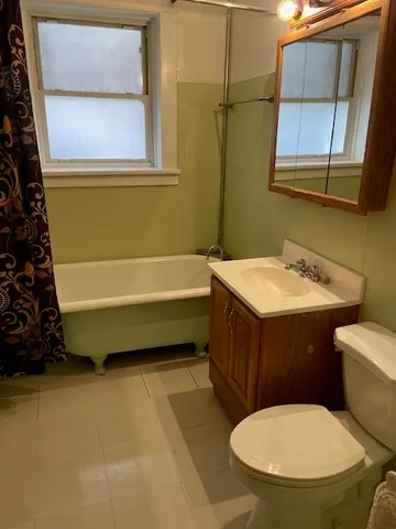 a bathroom with a sink a toilet and bathtub