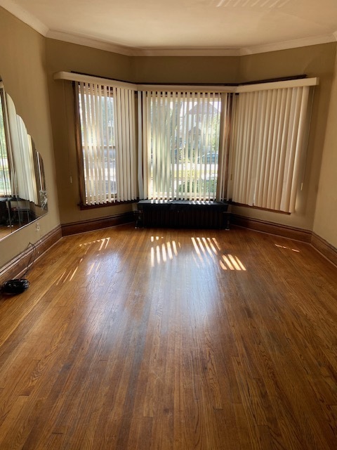 4022 West Cermak Road Chicago, IL 60623 - Photo 10 of 15 a view of a room with wooden floor and fireplace