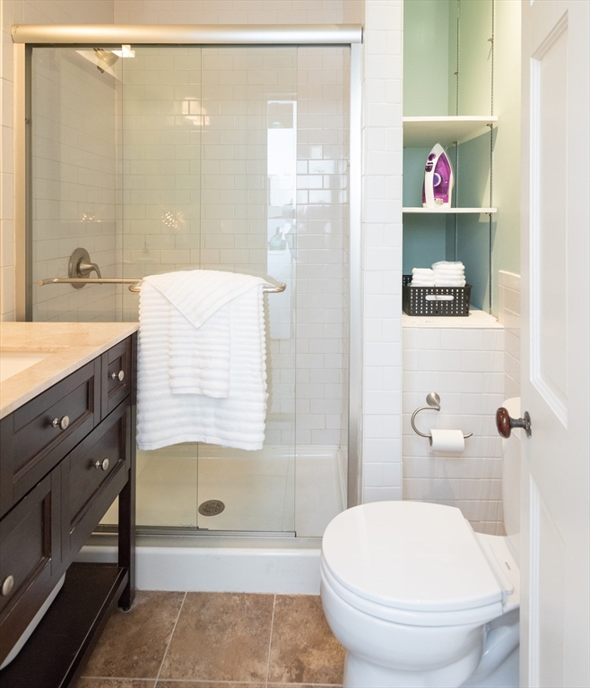 55 Linebrook Road, Unit 1 Ipswich, MA 01938 - Photo 11 of 25 a bathroom with a sink a toilet and shower