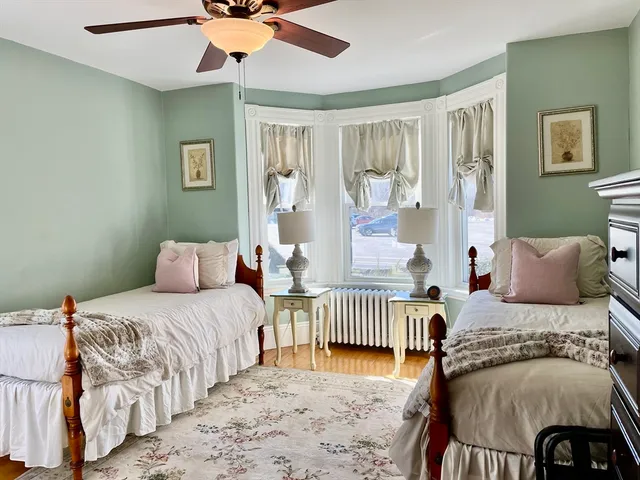 a bedroom with two beds and a table