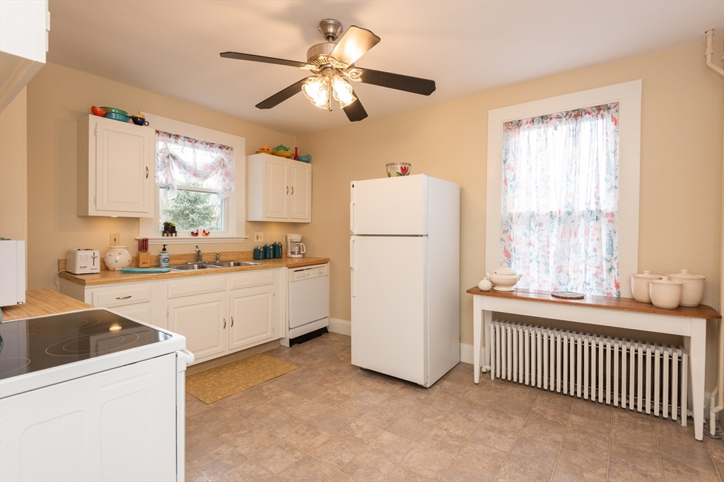 55 Linebrook Road, Unit 1 Ipswich, MA 01938 - Photo 17 of 25 a kitchen with white cabinets and white appliances