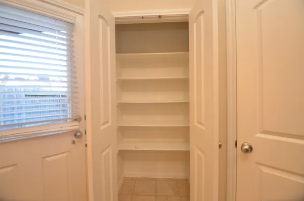 a view of walk in closet with empty racks