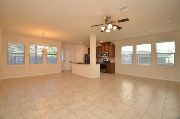 a view of an empty room with window and cabinet