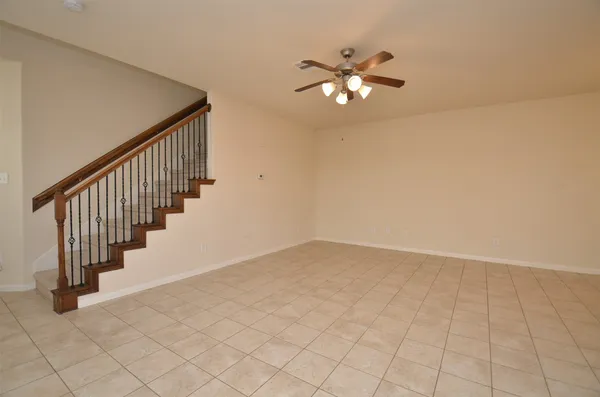 wooden floor in an empty room with a chandelier