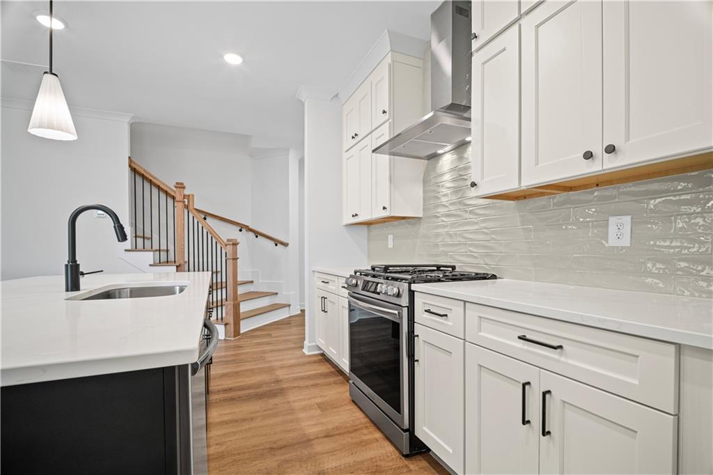 201 Retreat Lane Canton, GA 30114 - Photo 12 of 43 a kitchen with cabinets stainless steel appliances and a sink