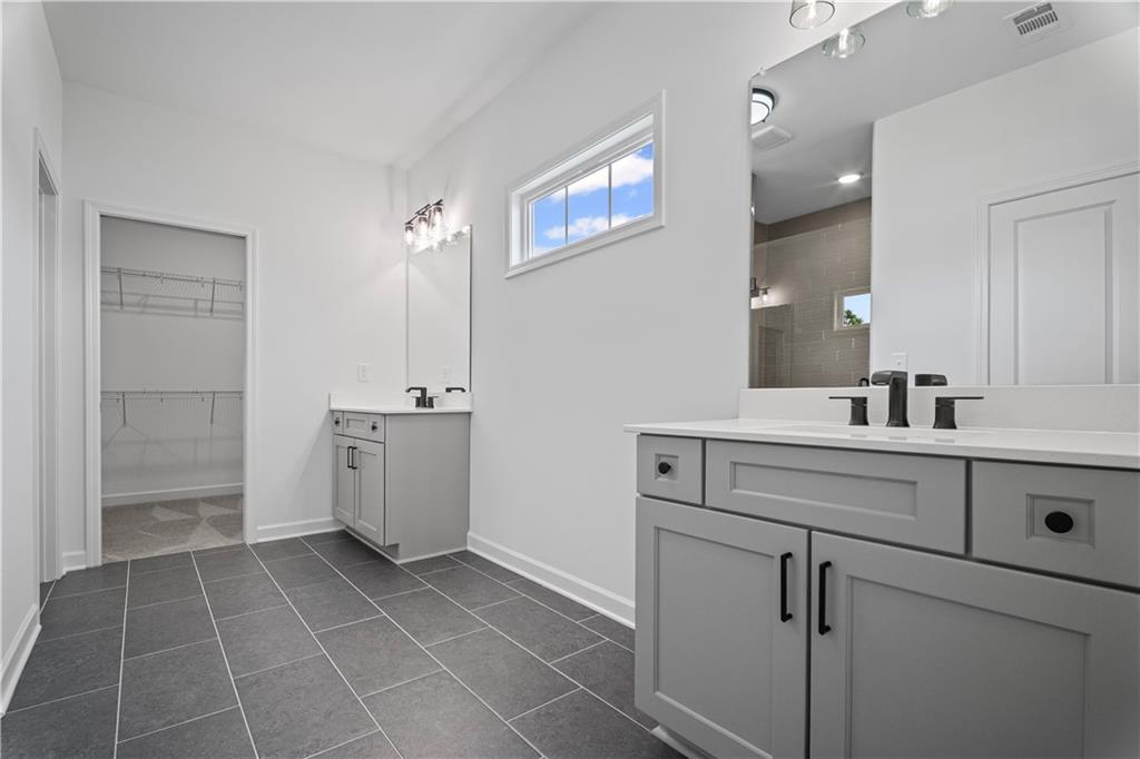 201 Retreat Lane Canton, GA 30114 - Photo 19 of 43 a bathroom with a sink a toilet and shower