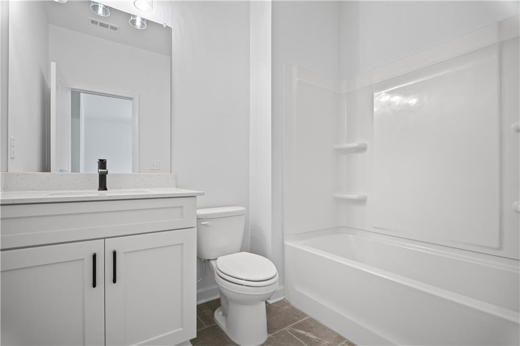 201 Retreat Lane Canton, GA 30114 - Photo 22 of 43 a bathroom with a toilet a sink and a bathtub