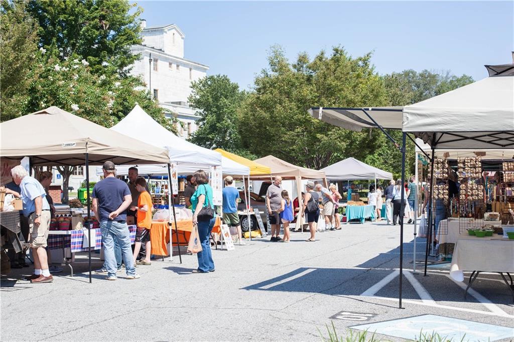 201 Retreat Lane Canton, GA 30114 - Photo 41 of 43 a group of people sitting under an umbrella in front of retail shop