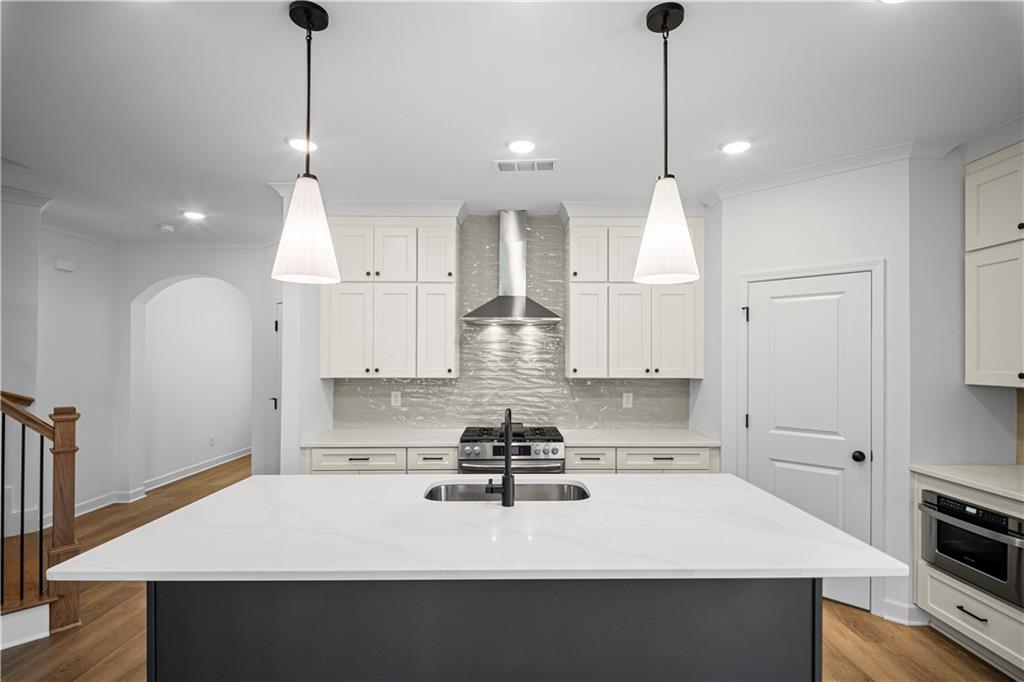 201 Retreat Lane Canton, GA 30114 - Photo 6 of 43 a kitchen with kitchen island white cabinets and stainless steel appliances