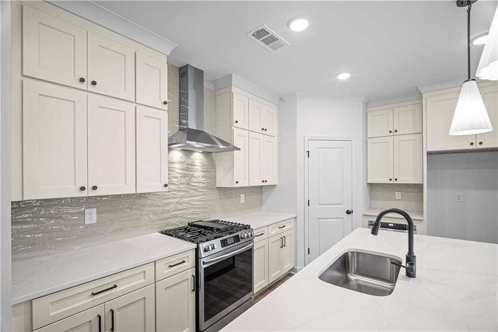 201 Retreat Lane Canton, GA 30114 - Photo 7 of 43 a kitchen with granite countertop a sink stainless steel appliances and white cabinets